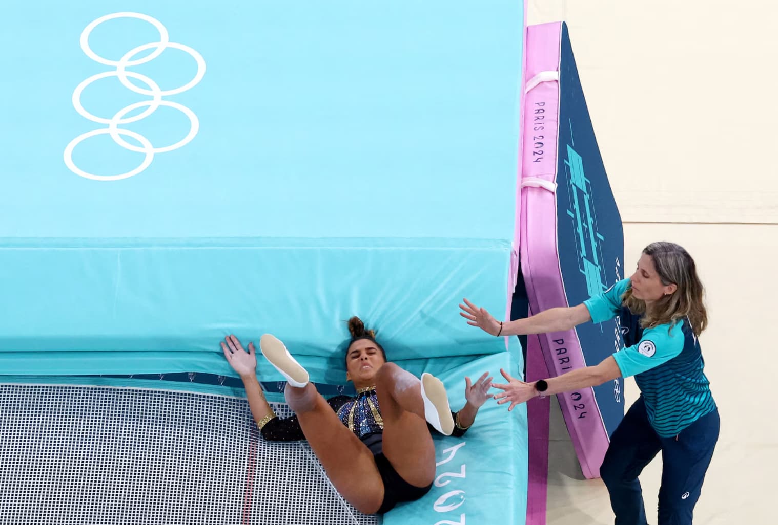 Egyptian athlete Malak Hamza falls during her trampoline routine.